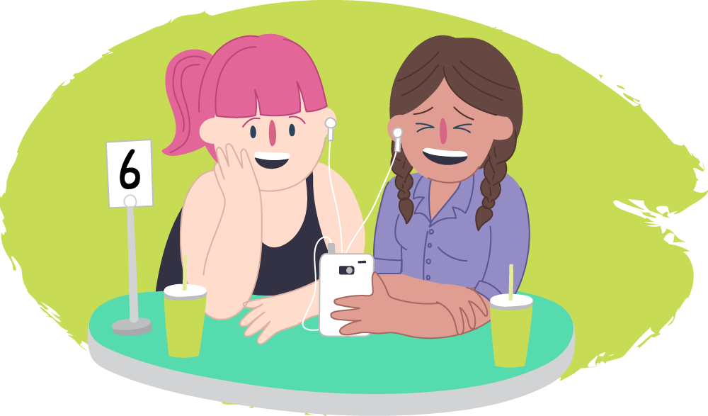 Two teen girls in a cafe laughing over their phones together Two teen girls in a cafe laughing over their phones together